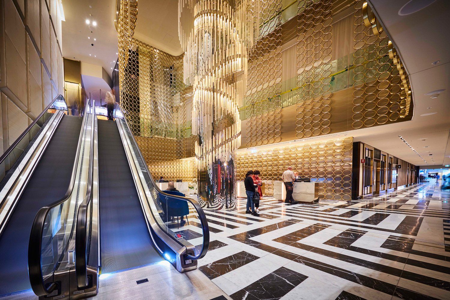 Grand hotel lobby with elegant chandelier and marble floors